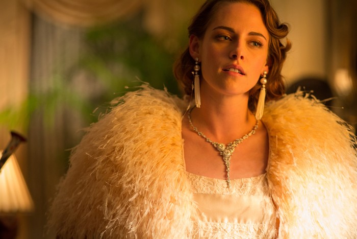 A still from "Cafe Society" showing Kristen Stewart in a custom-made light pink silk and lace Chanel dress and Chanel fine jewelry